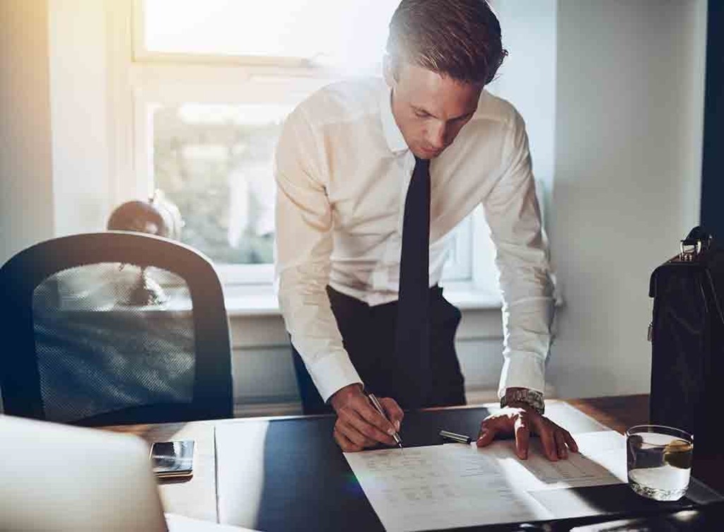 bussinessman at desk, signs your husband is cheating