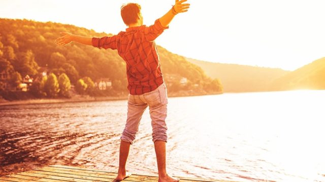 happy man standing on the shore, smart person habits