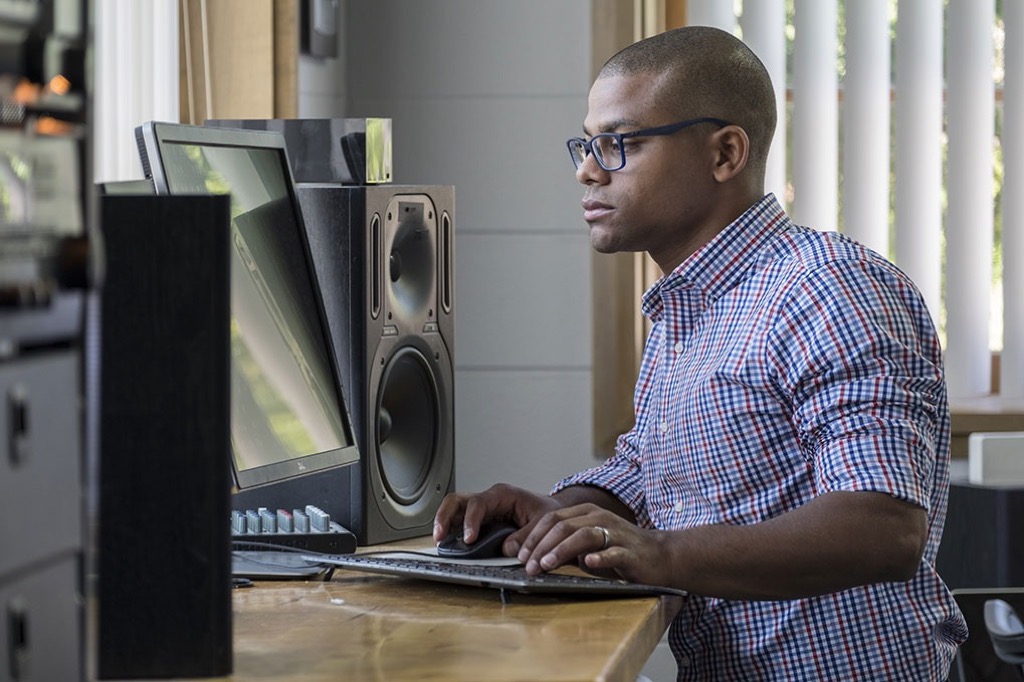 man at standing desk ways to de-stress