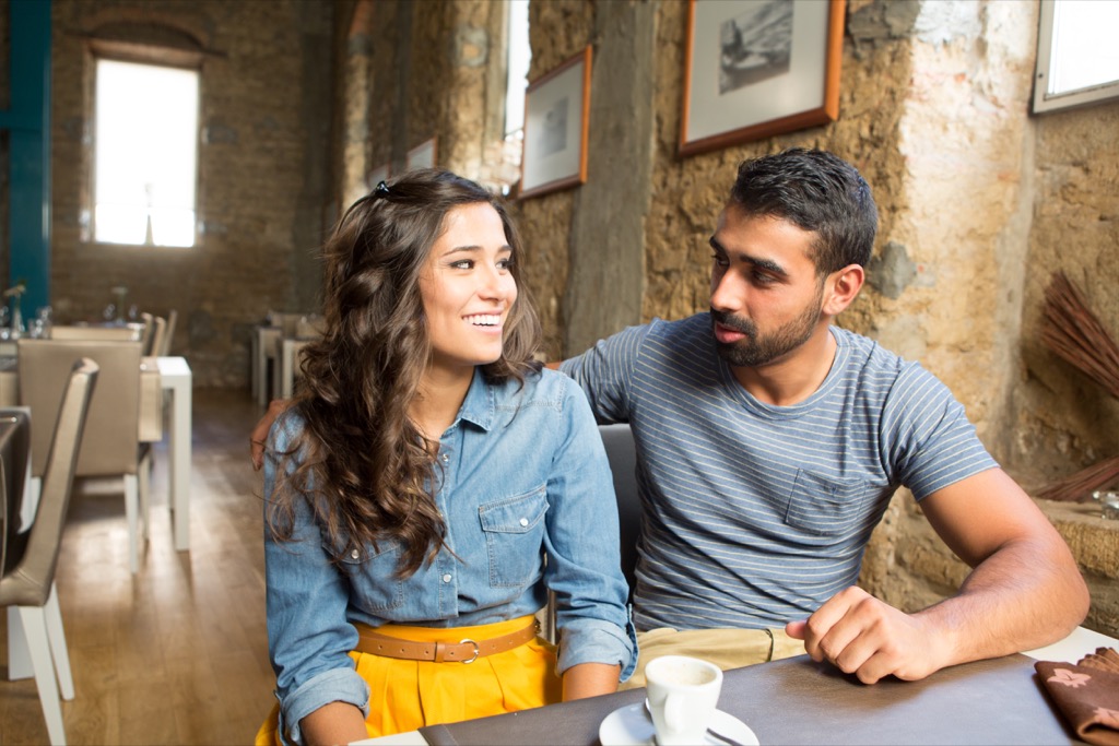 Young couple talking in a restaurant about open marriage.