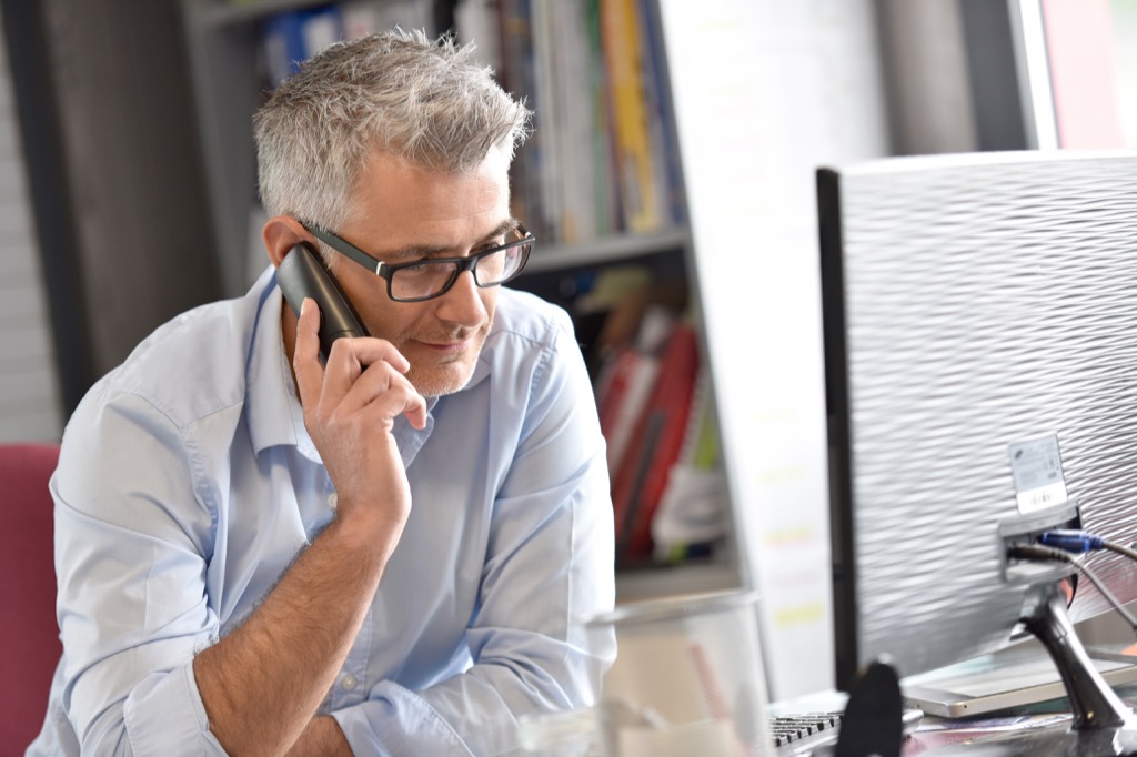 Man on the phone, divvying up tasks. It's a sign of great productivity.