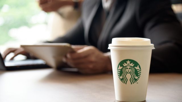 Starbucks coffee order and a man with a tablet.