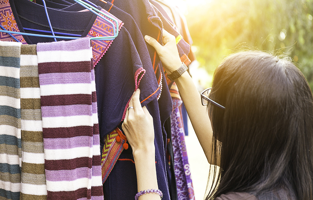 woman browsing thrift store in sinlight