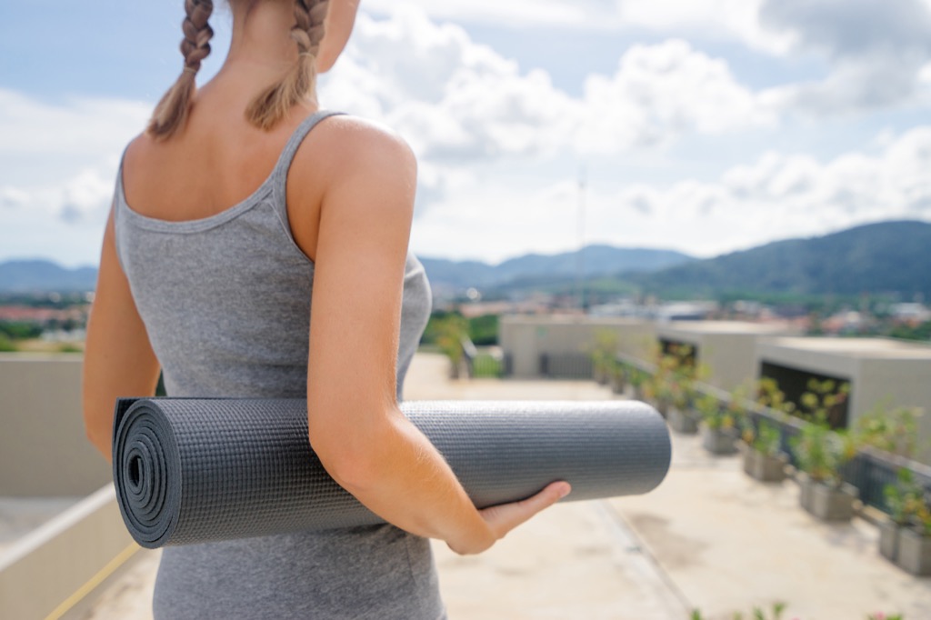 woman doing yoga outside, weight loss motivation