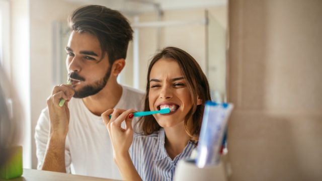 couple brushing teeth