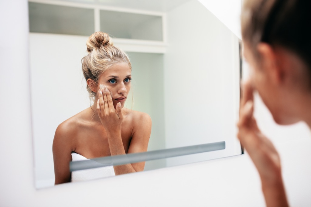 woman applying skin cream, healthy skin after 40