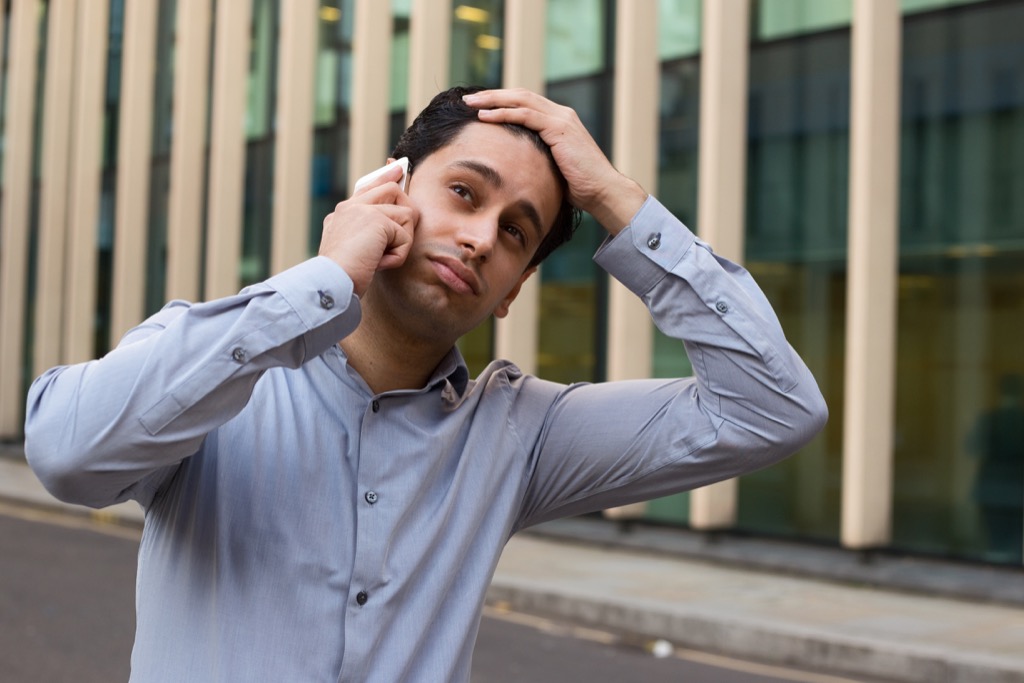 Man on phone looking upset