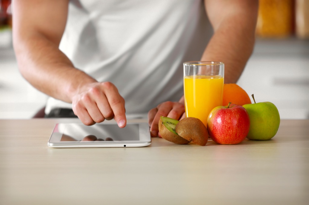 man tracking his eating habits on a tablet, weight loss motivation