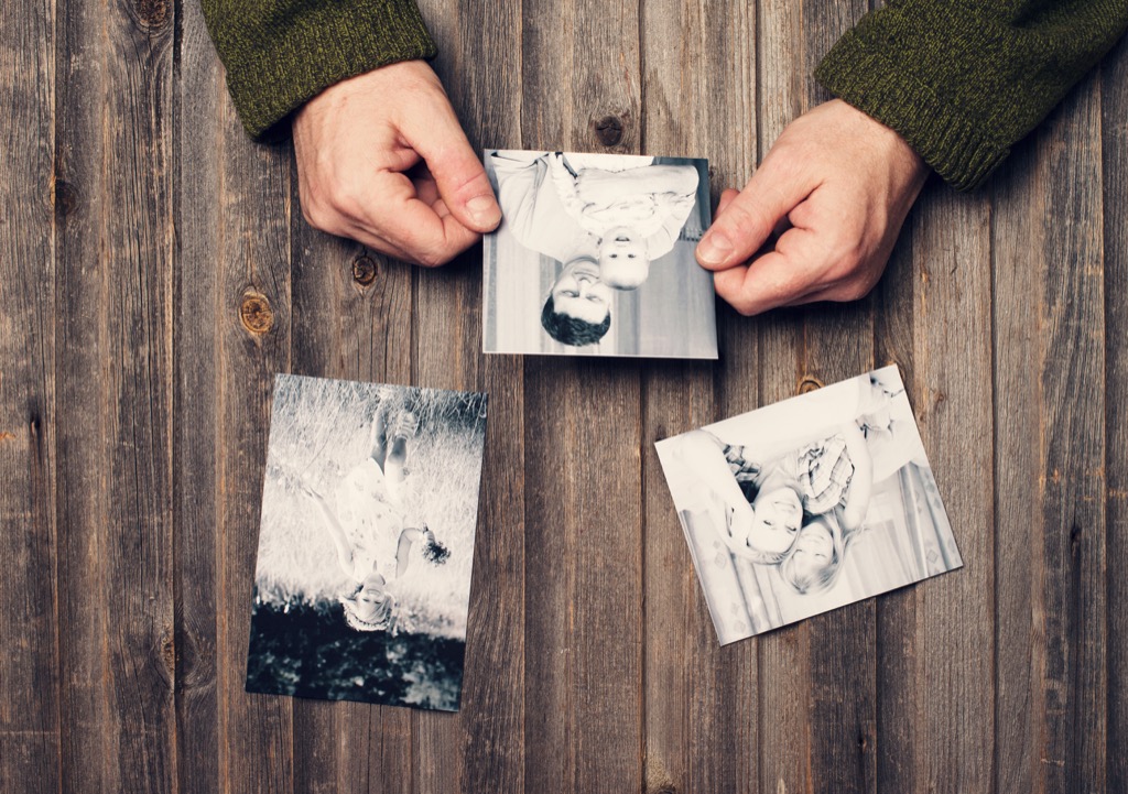 man looking at old photos