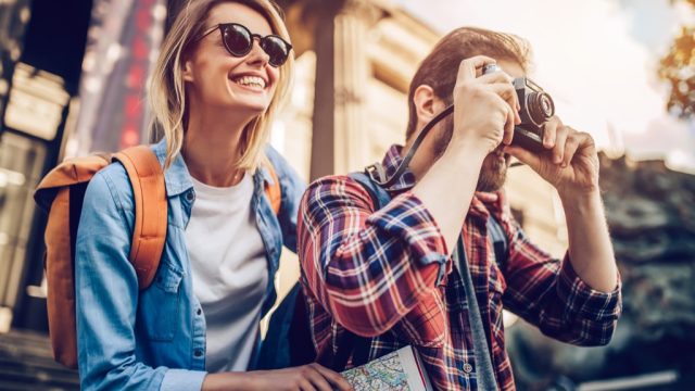 a woman and a man traveling and taking photos