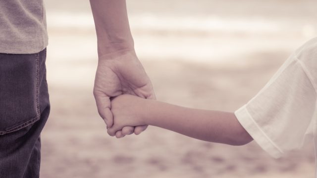 Father and son holding hands.