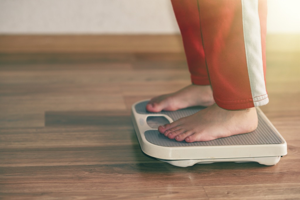 person standing on a scale, weight loss motivation