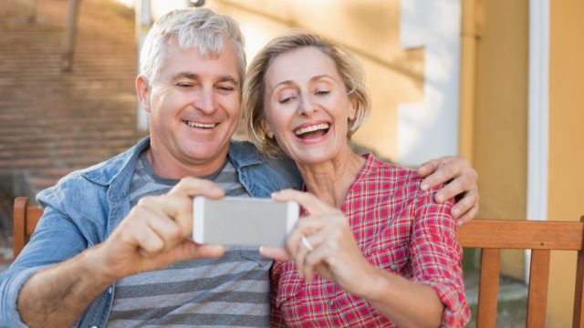 older couple taking photo, relationship white lies