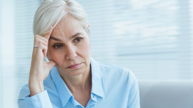 older woman looking sad, empty nest
