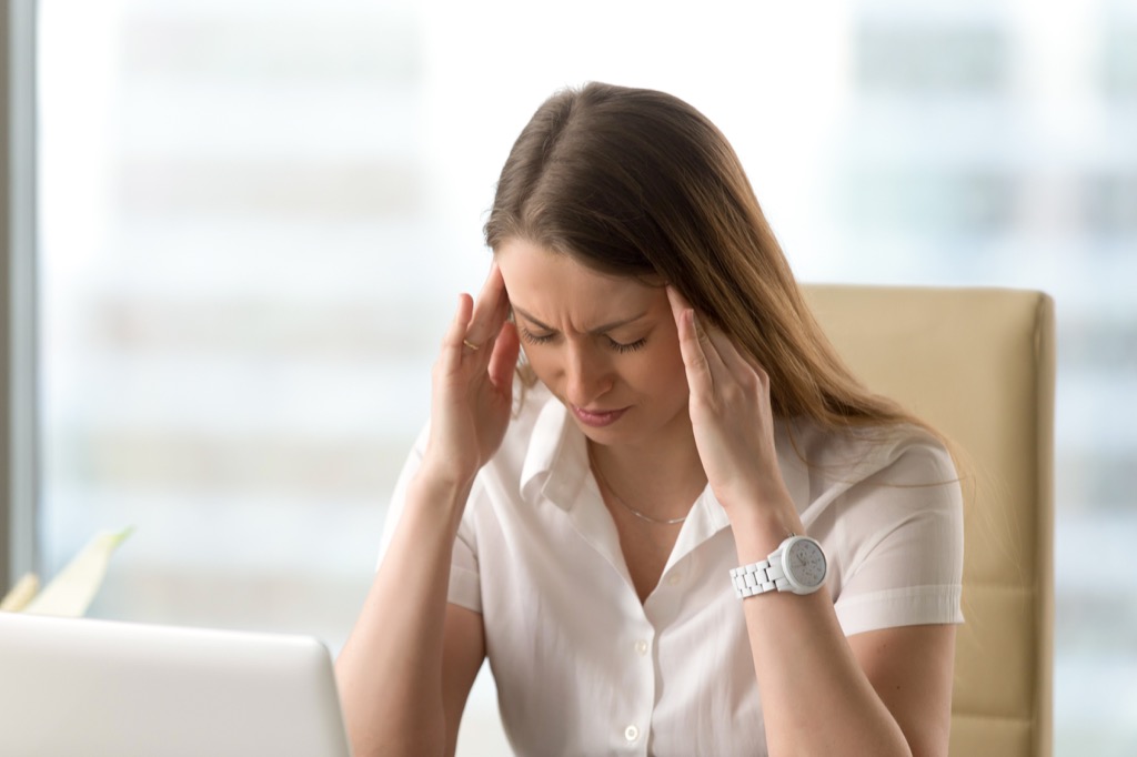 woman holding her head in confusion