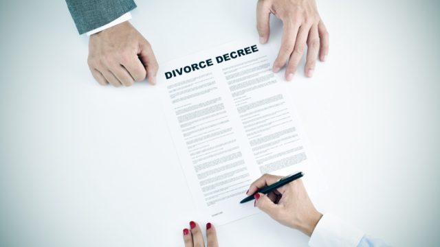 couple signing divorce papers, empty nest
