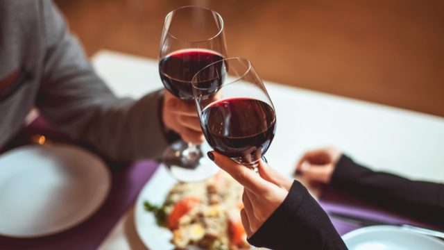 people drinking wine at dinner