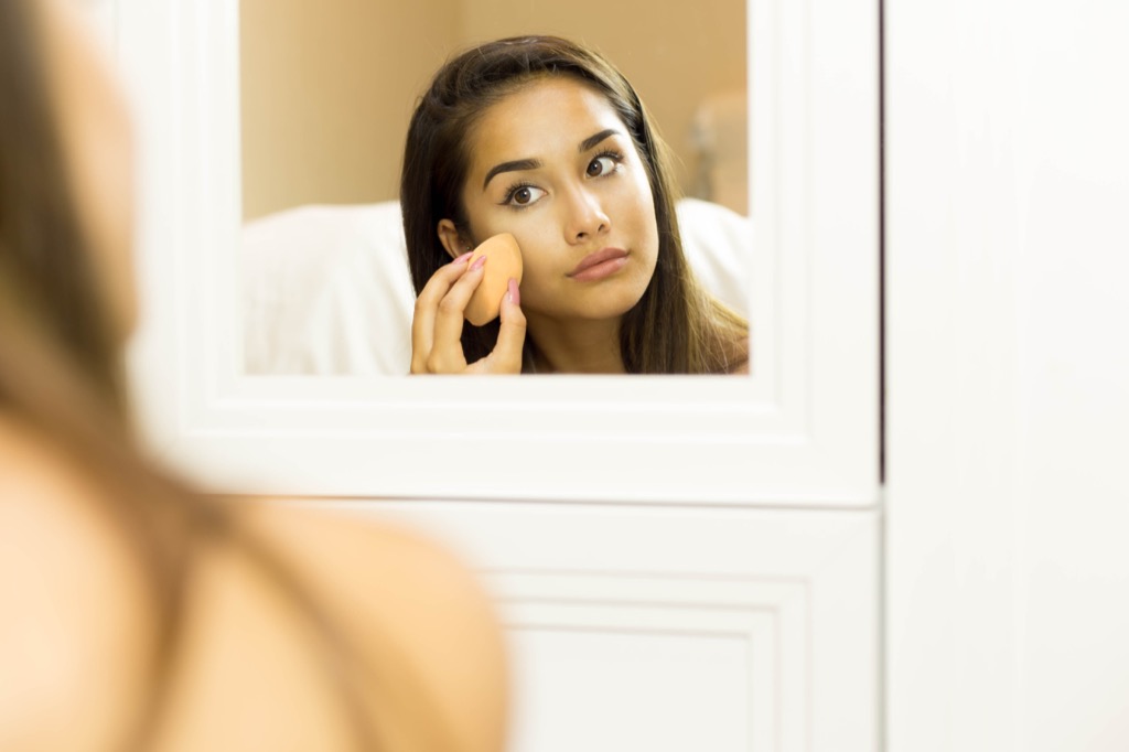 Woman Applying Foundation Anti-Aging