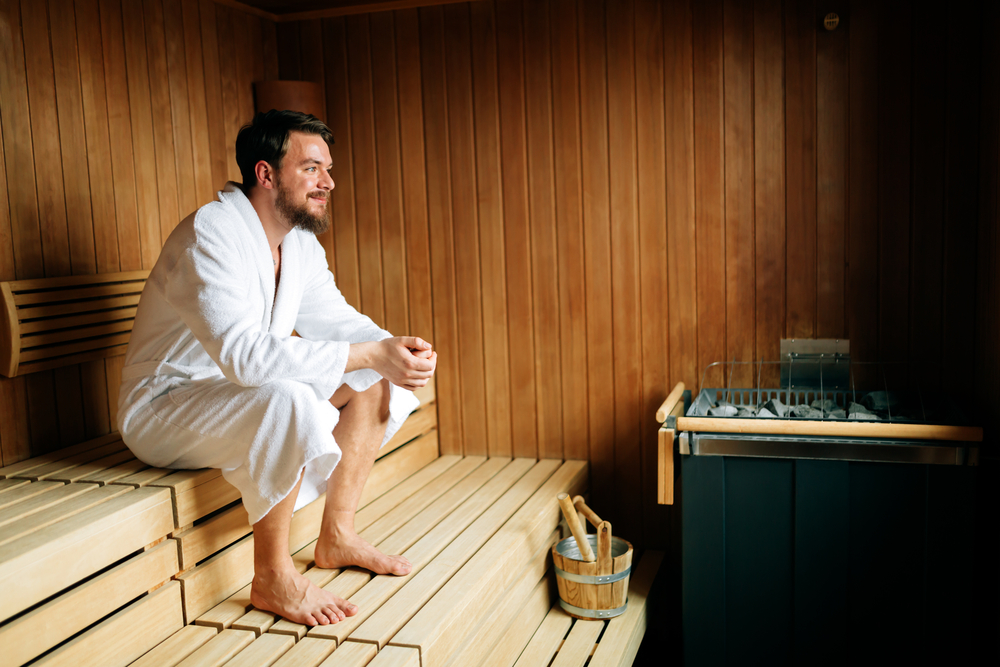 man sitting in sauna