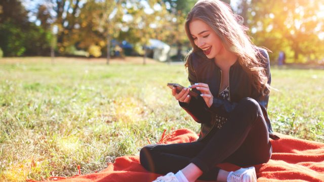Girl Smiling at Phone Romance