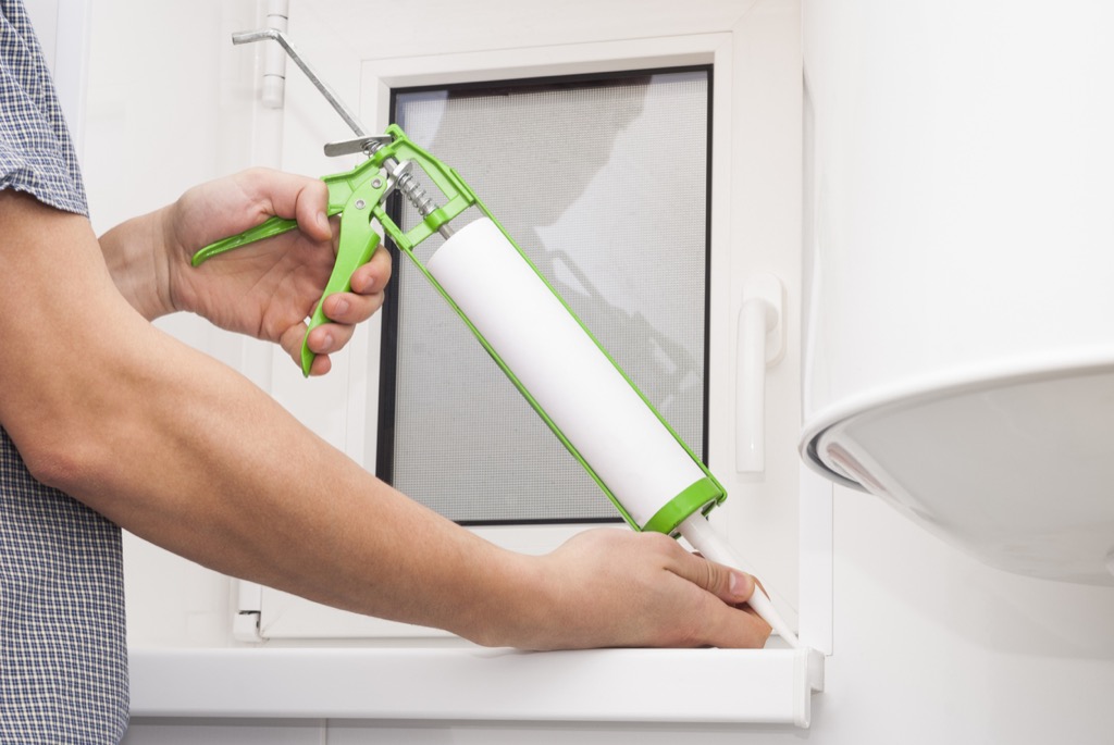 Man caulking crack
