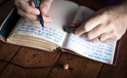 Close up on person writing in journal