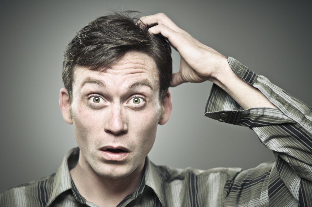 confused man scratching his head about riddle