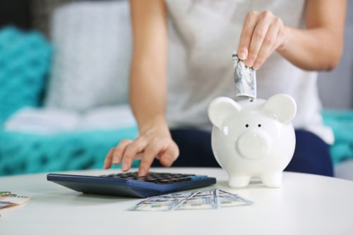 putting money into piggy bank, stay at home mom