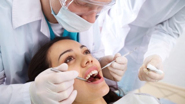 Woman getting her teeth looked at at the dentist's office