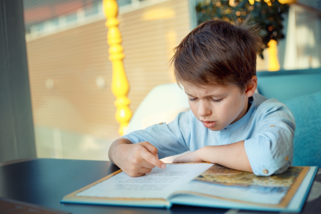 boy struggling to answer riddle