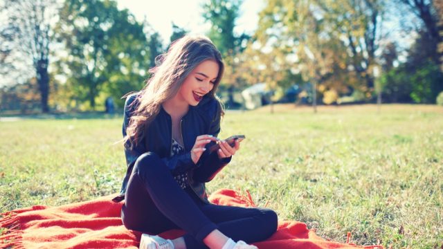 woman with smartphone in park