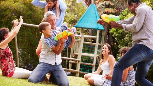 families playing with waterguns at park 20 surprising ways fatherhood changes you