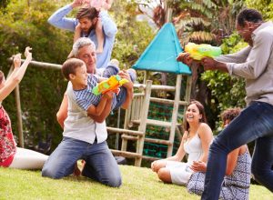 families playing with waterguns at park 20 surprising ways fatherhood changes you