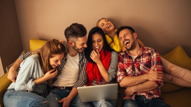 group of friends laughing at computer, bad jokes
