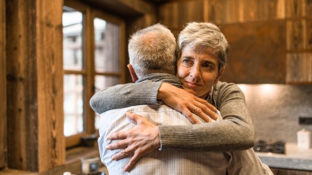 senior couple embracing at home