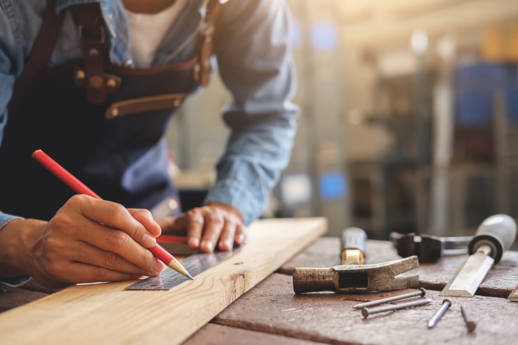 carpenter measuring wood
