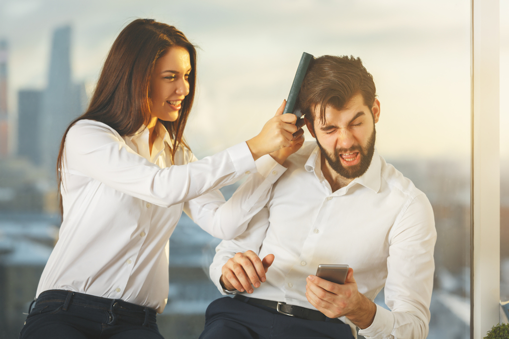 woman playfully hits coworker