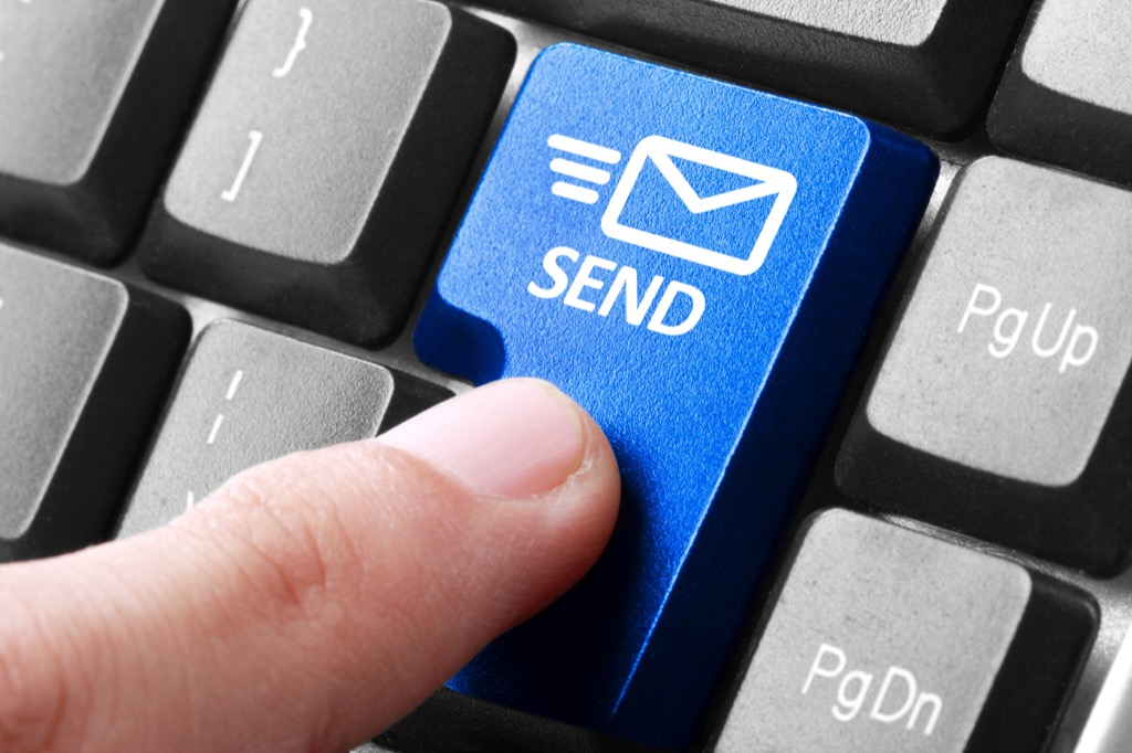 close up of finger pressing "send" button on keyboard