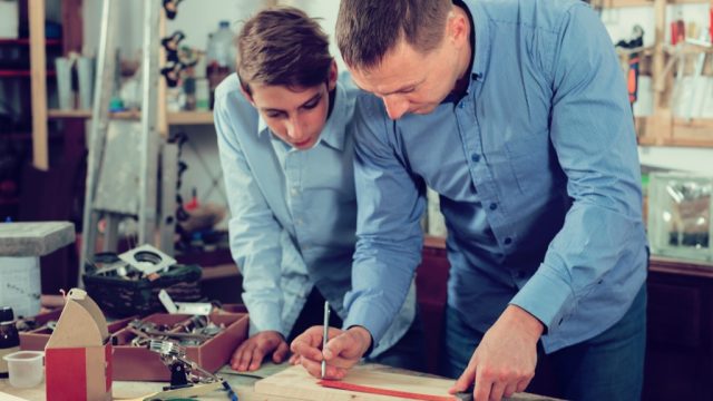father and son doing carpentry