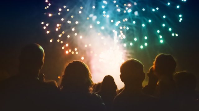 a crowd of people gathered to watch july 4th independence day fireworks