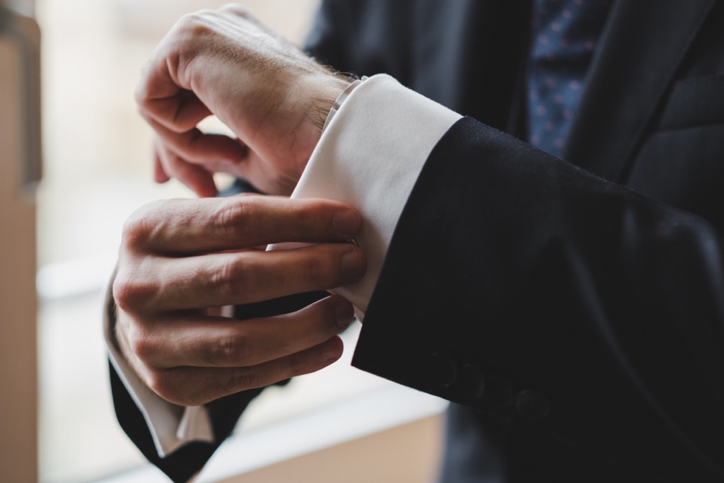 man in suit with cufflinks, craziest things brides and grooms have ever done