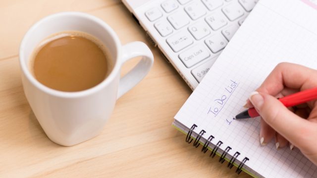 Woman being productive and writing a to-do list, ways to feel amazing