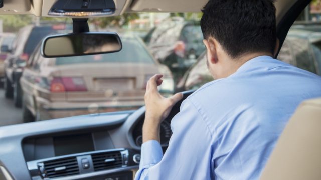 Man sitting in traffic angry