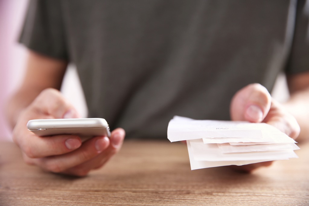 man with stack of bills, ways to feel amazing