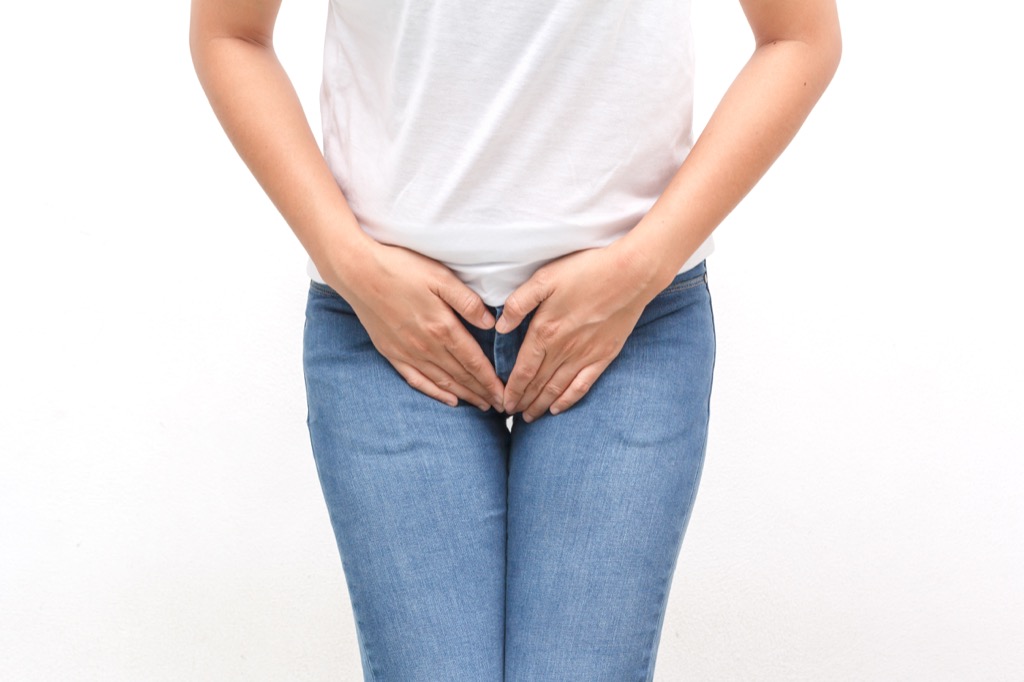 Woman who needs to use the bathroom holding her pelvis
