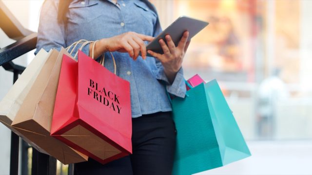 woman shopping on black friday with bag that says "black friday" on it