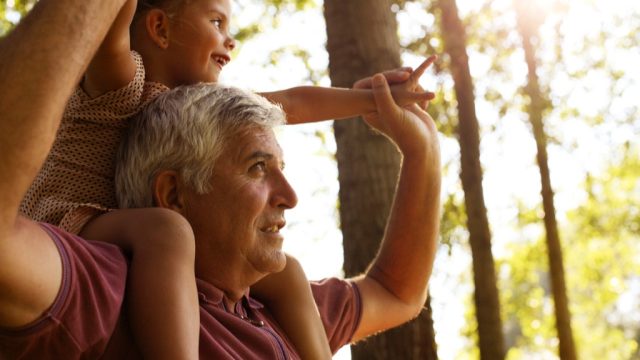 grandparent and grandchild in the woods