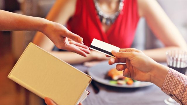 man paying for dinner with a credit card