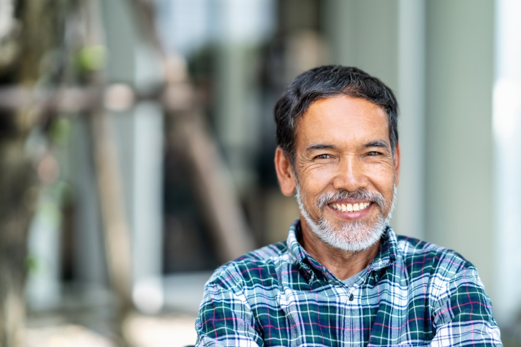 older man smiling outdoors, look better after 40
