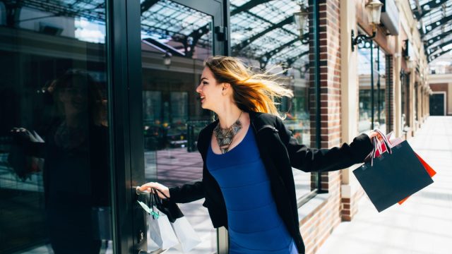 Woman shopper runs to store to save money on clothes